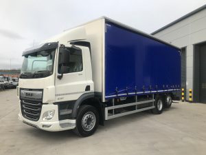 left side view of a blue daf curtainsider truck